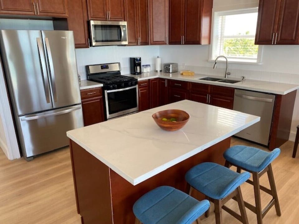 The gourmet kitchen with stainless steel appliances and filtered water.