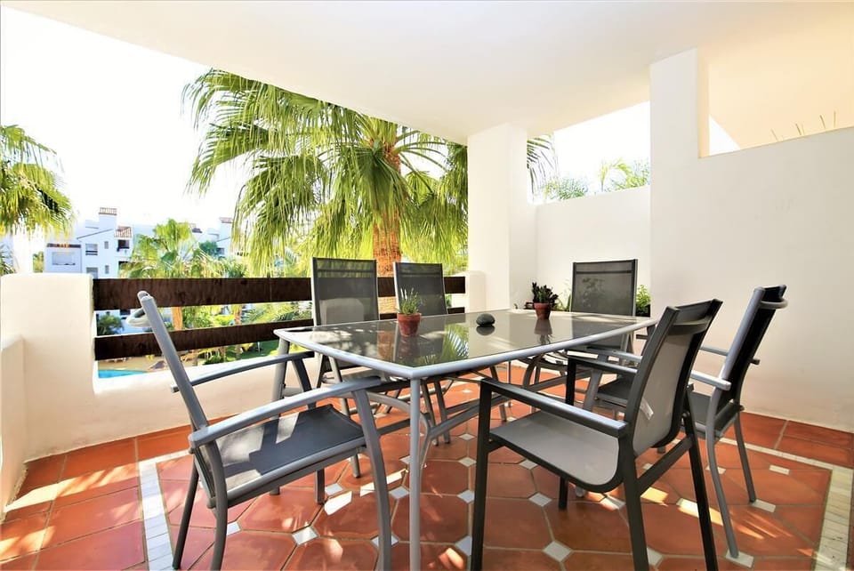 Another view of the balcony with outside dining area for six guests