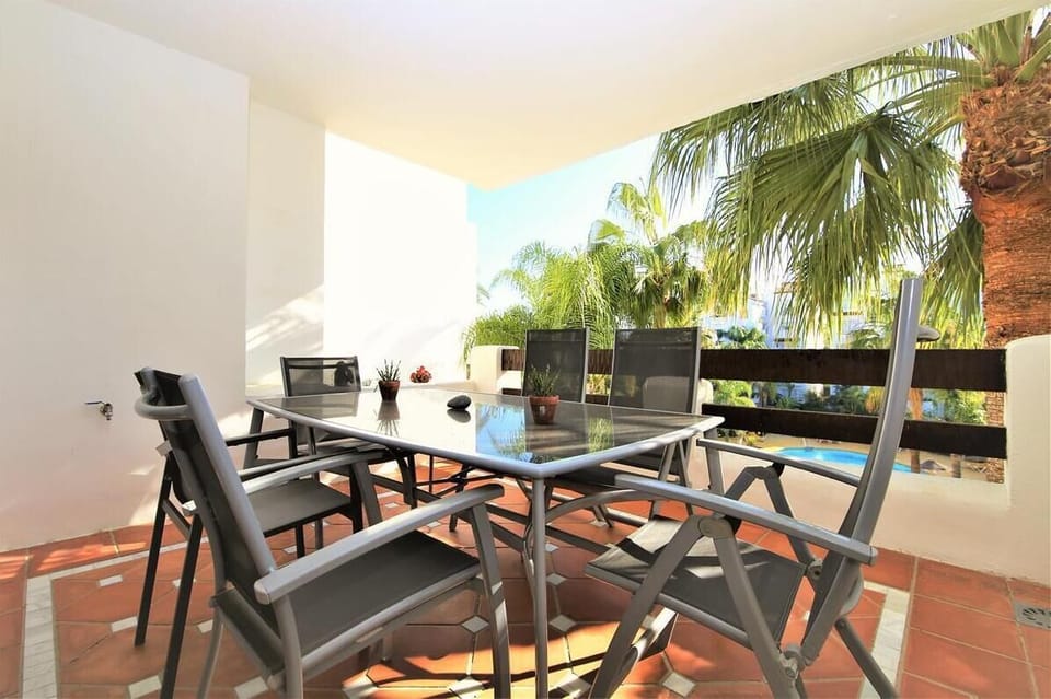 Lovely balcony overlooking the pool with dining table for up to six guests