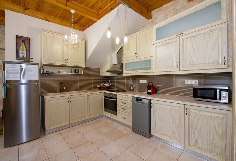 The kitchen is fully equipped with all the necessary electrical appliances.