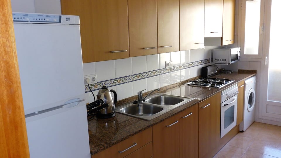 Shows part of the kitchen
