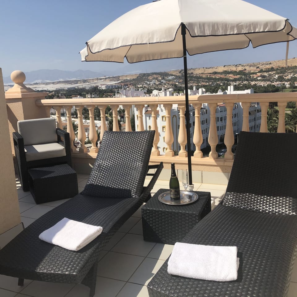 Luxury Palm Aire woven rattan chaise reclining sun-loungers. 