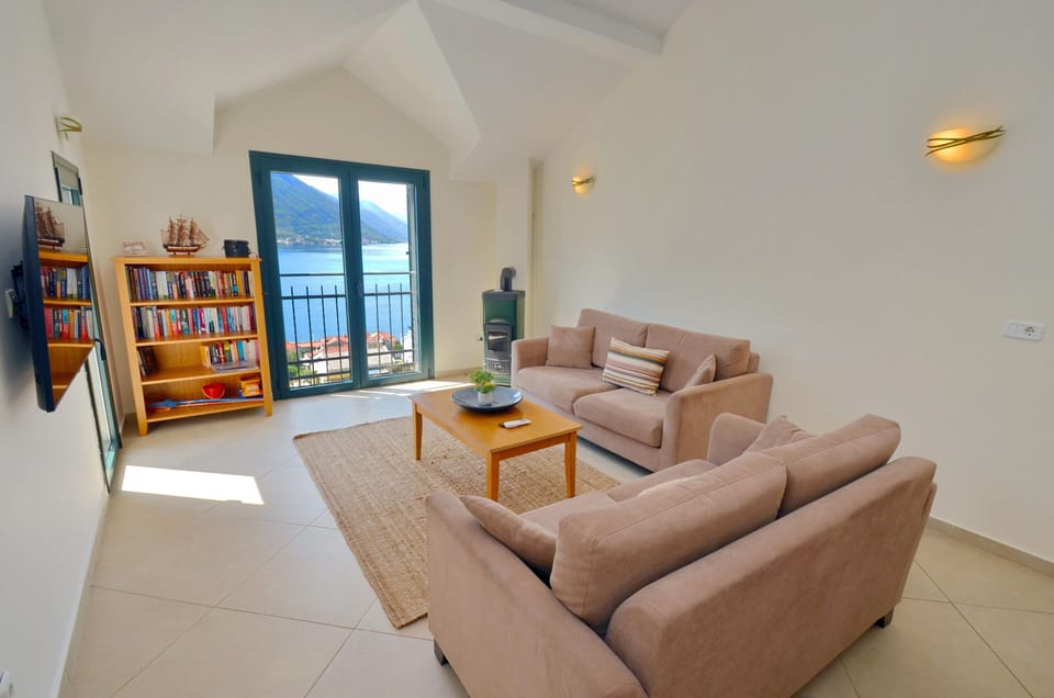 Your lounge with smart TV, books and view across Boka Bay.