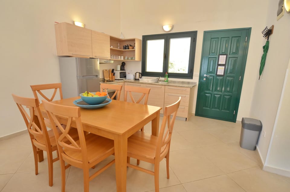 Dining room and kitchen with hob, oven, microwave, fridge/freezer,coffee machine
