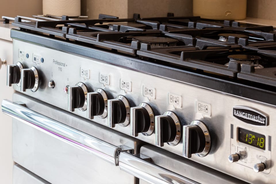 Professional range cooker in kitchen ith three ovens