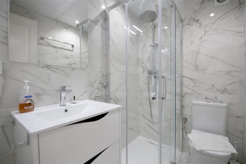 Family bathroom with shower, toilet and hand-basin