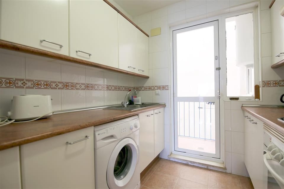 Another picture of the kitchen with access to an indoor terrace