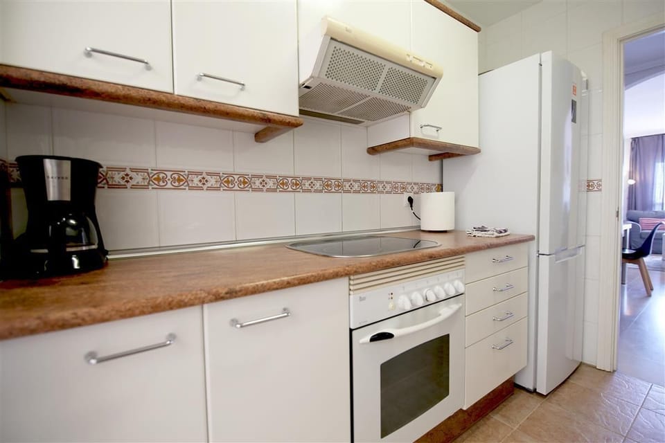 Kitchen in this apartment is fully equipped with all the appliances