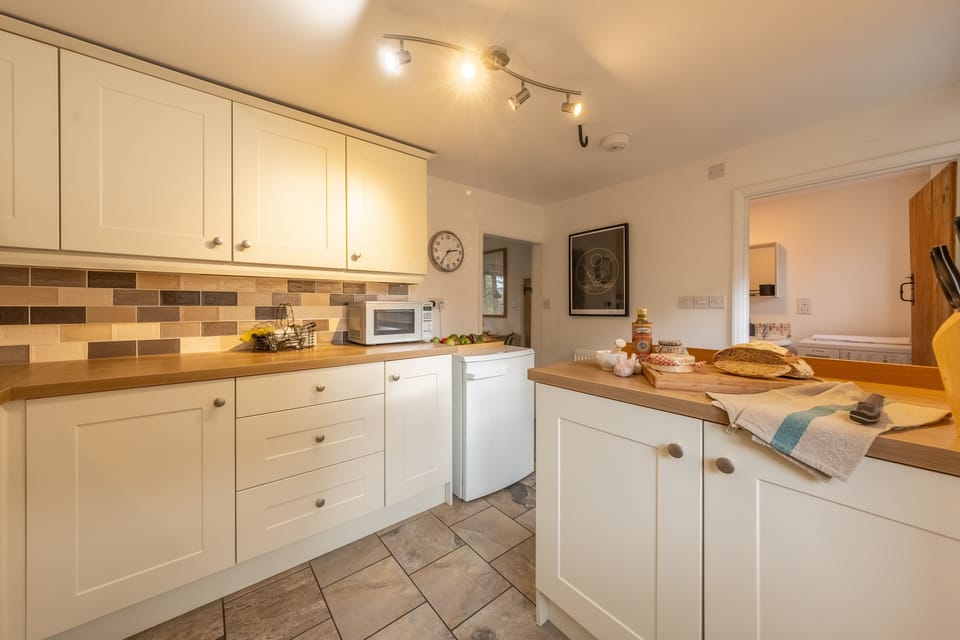 Ground floor: The kitchen has an additional shower / utility room off it