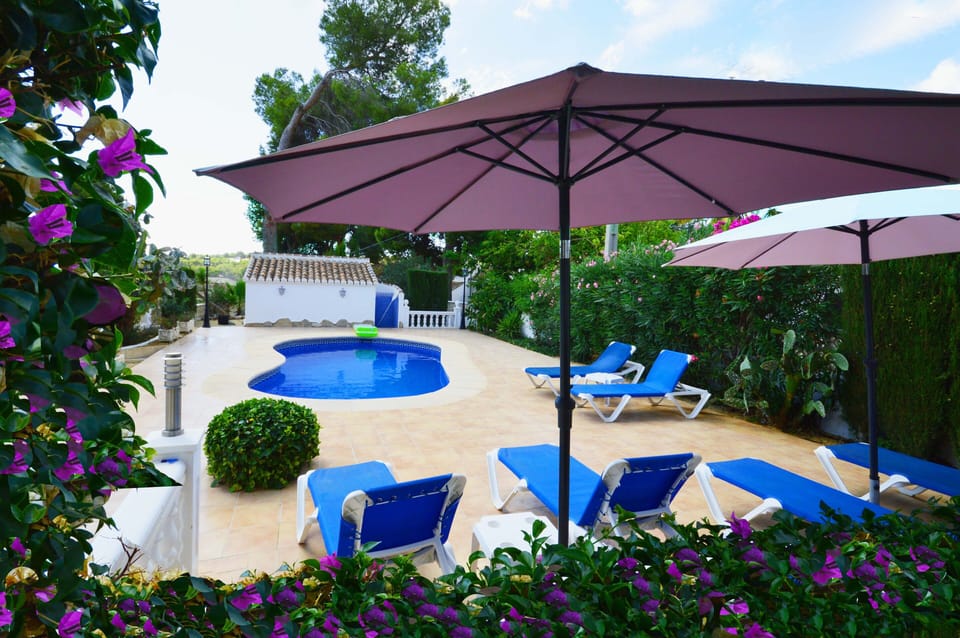 Pool, gardens with pool house in the background
