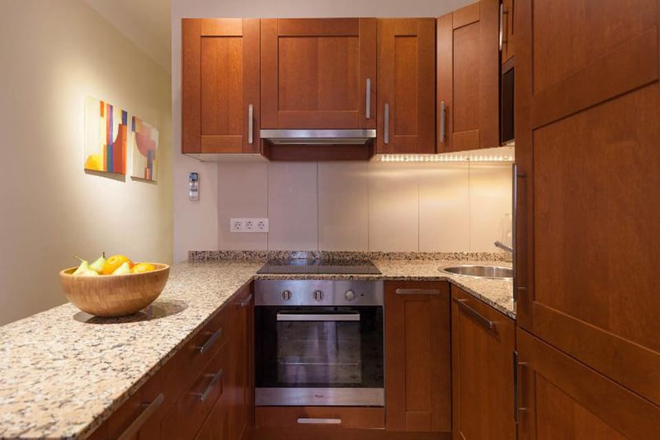 The open kitchen is fully equipped with modern appliances.