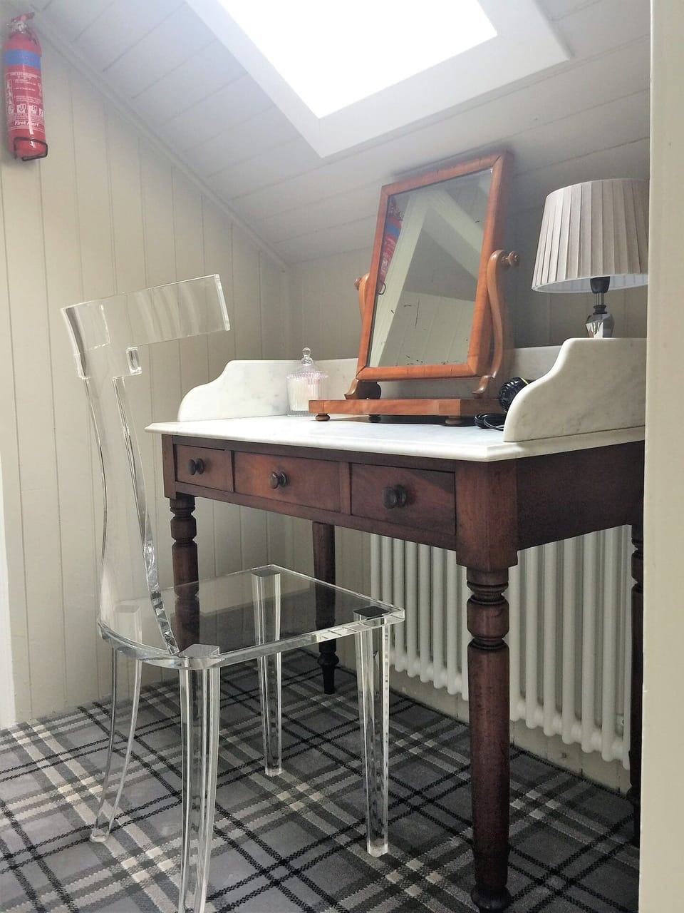 A second vanity table, with acrylic 'ghost' chair.