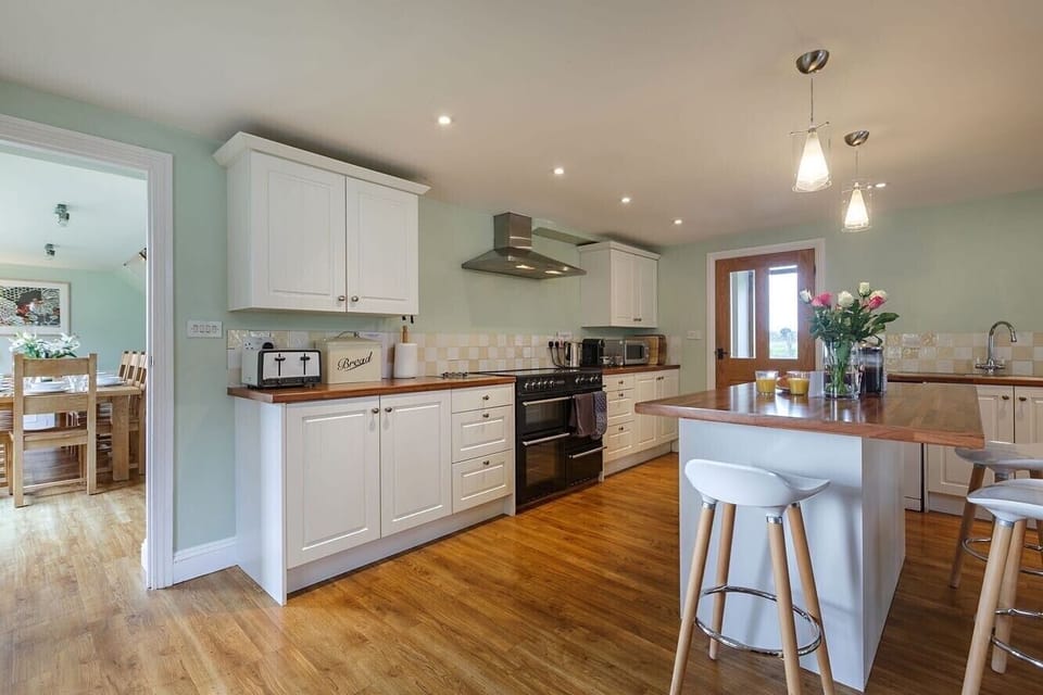 The kitchen features an electric range cooker, microwave and Nespresso machine 
