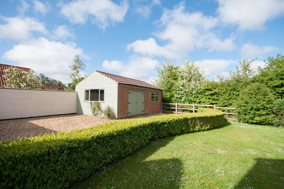 Back garden with parking area.  Garage housing table-tennis