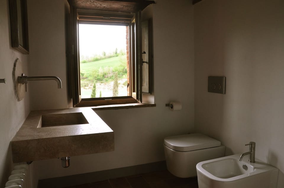 luxury bathroom 1 in travertine marble and brushed stainless steel