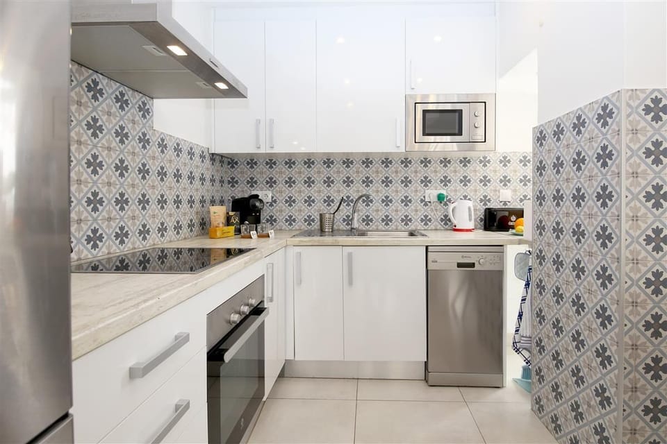 Modern open kitchen is fully fitted with all the appliances