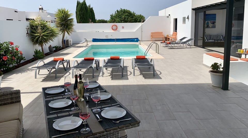 Relax and alfresco dine on super comfy sofas/dining table under covered pergola.