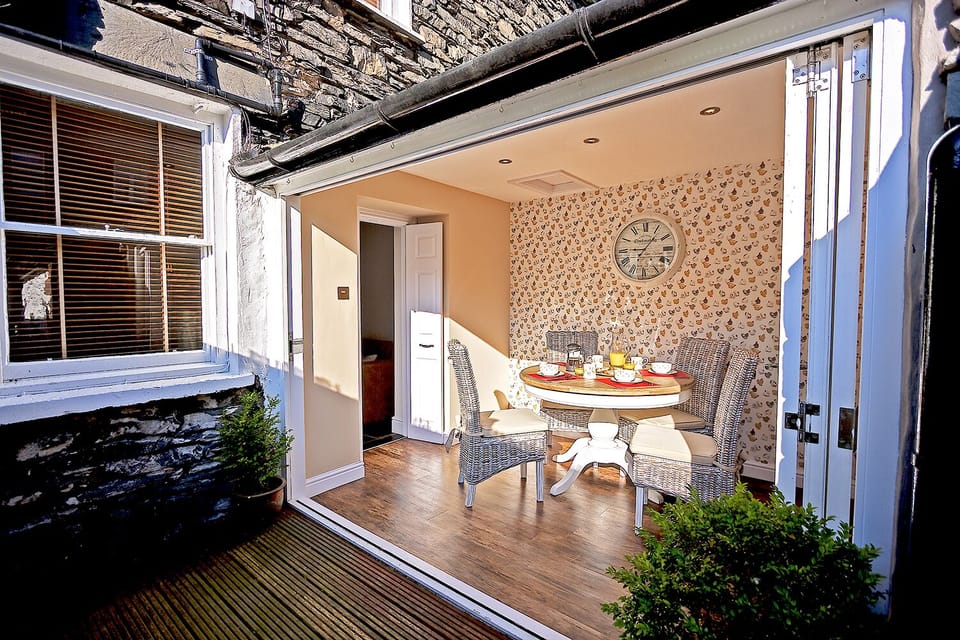 Bright & airy breakfast room with tri-fold patio doors.