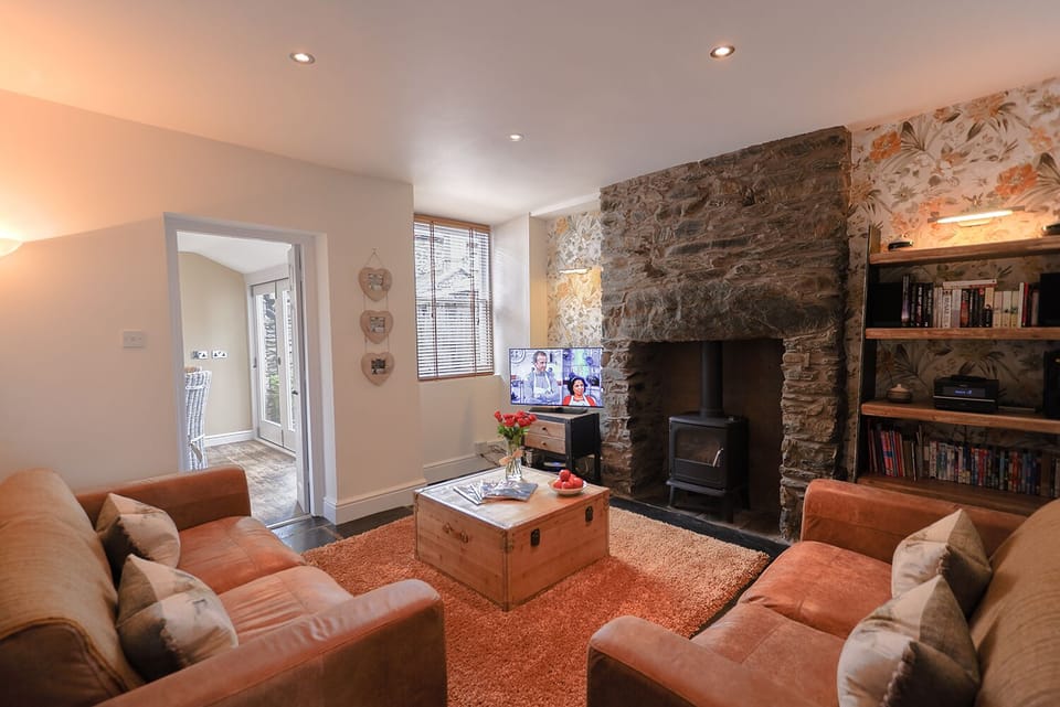 Cosy, bright lounge with multi fuel stove.