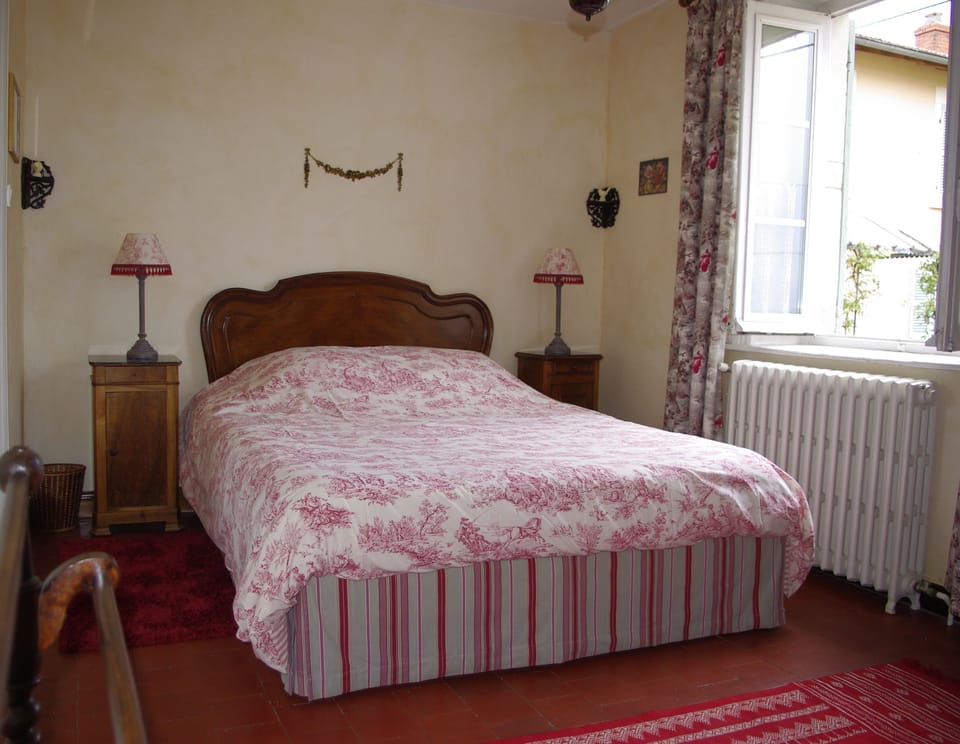 Red bedroom with en suite bathroom and east and west facing windows