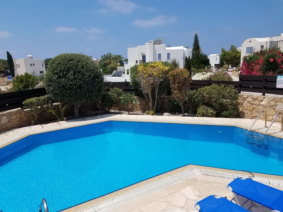 Pool with manicured garden with view to the sea