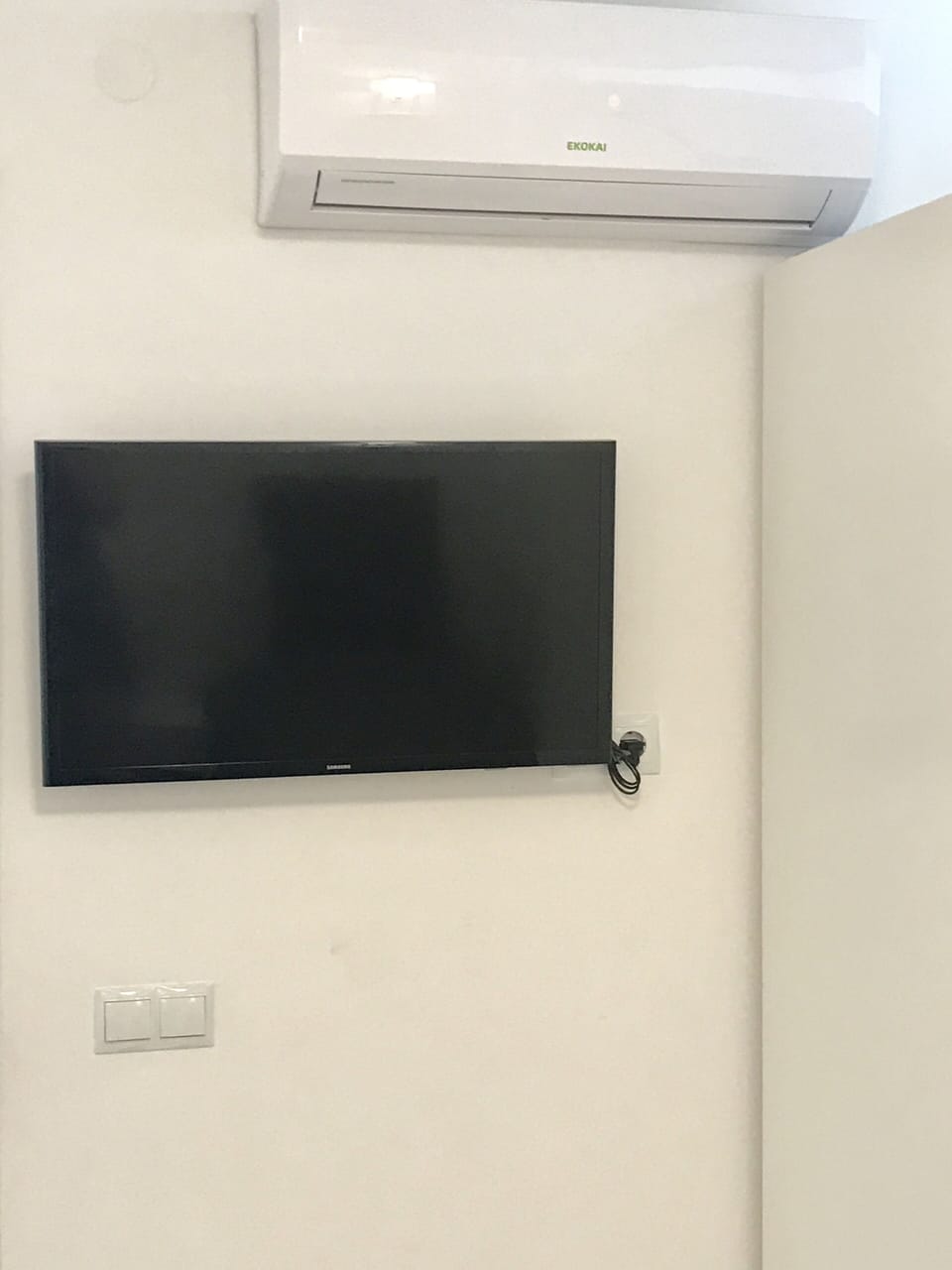 TV and AC on wall in both 2 main bedrooms. 