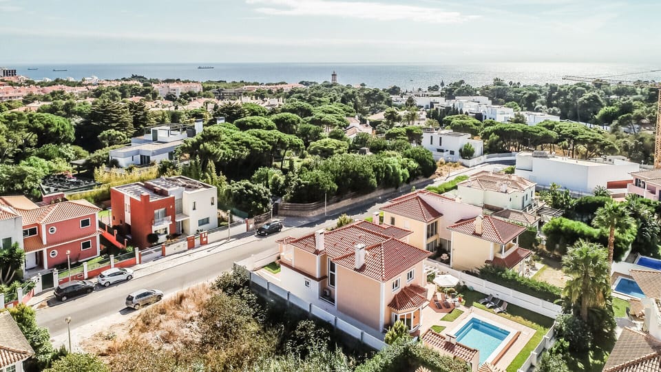 Aerial view of contemporary villas with terracotta roofs and private pools — Villa Quinta da Marinha II, luxury holiday villa in Cascais