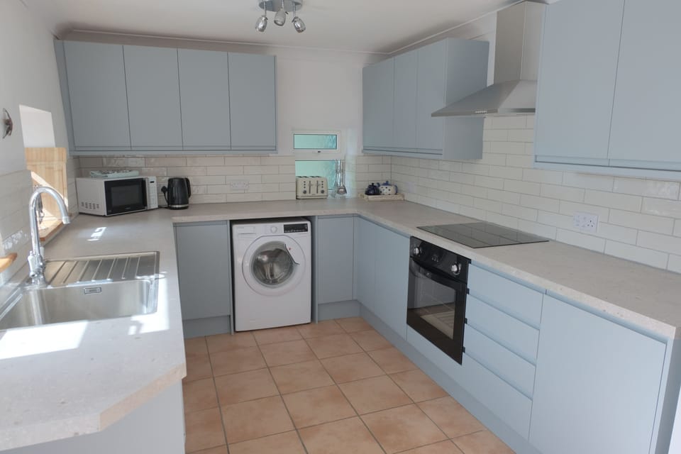 Kitchen with dishwasher, big fridge freezer and washing machine