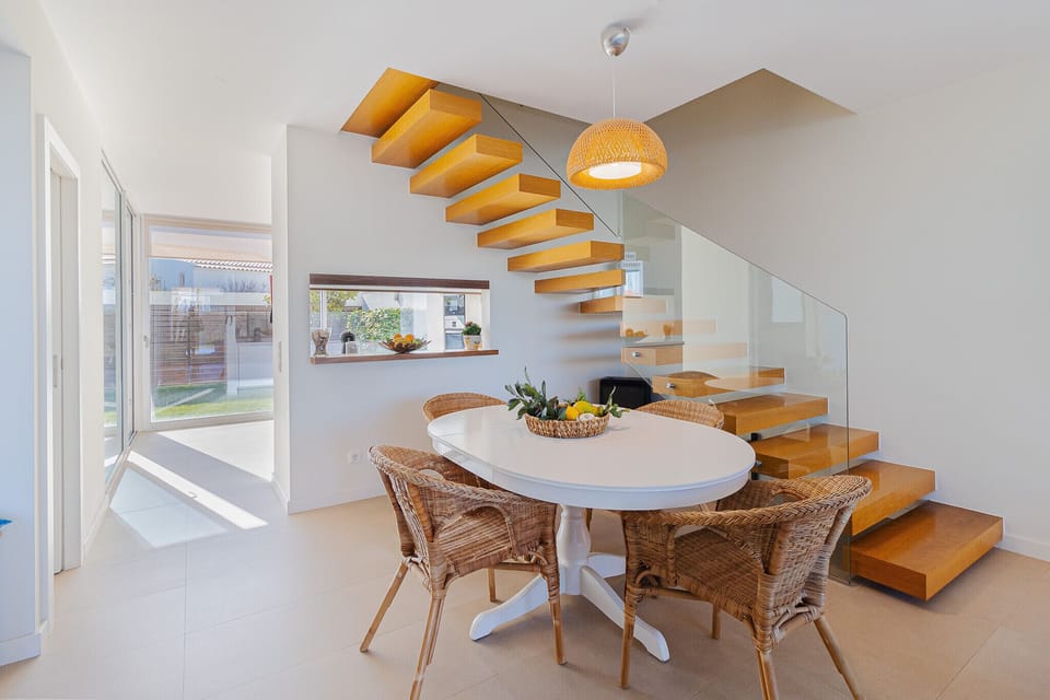 Open-plan dining area with floating wooden staircase — Villa Blue Sagres G, holiday villa in Vila do Bispo