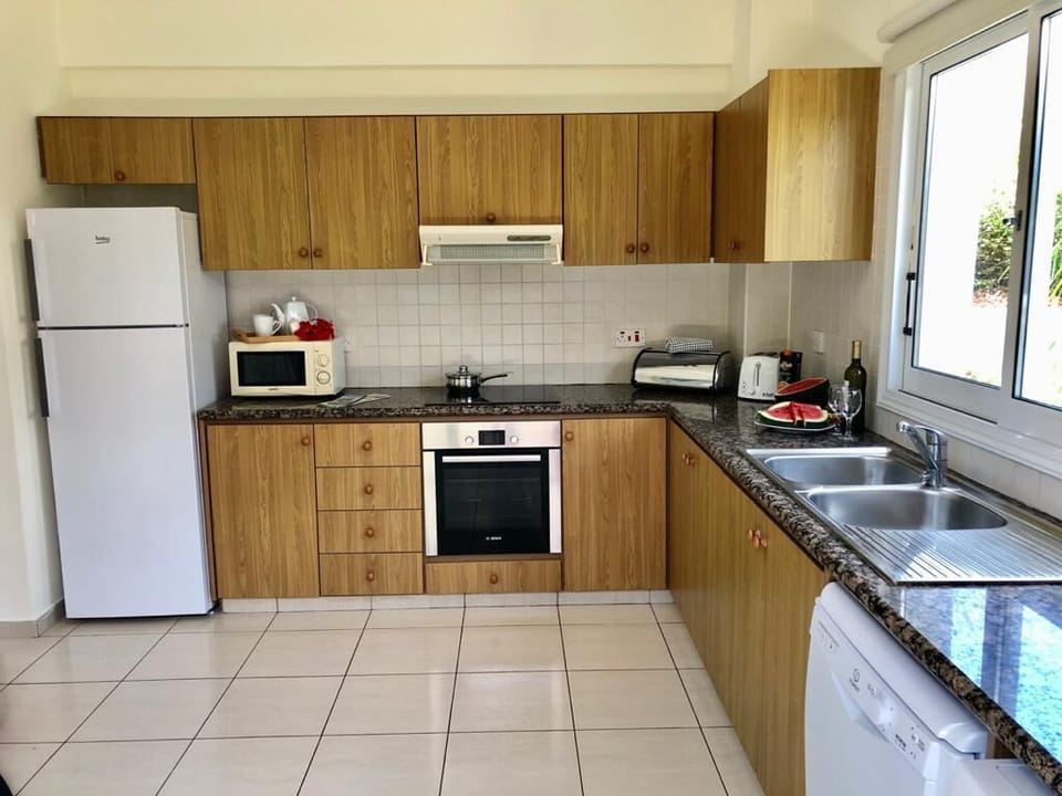 Modern fully equipped kitchen with floor to ceiling sliding doors to front patio