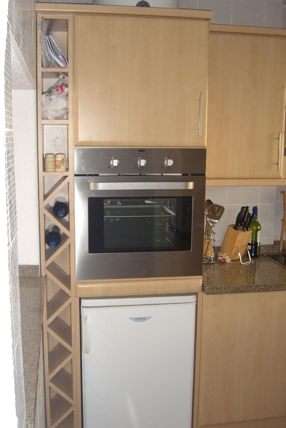 Kitchen with Cooker, Fridge and Wine Rack

