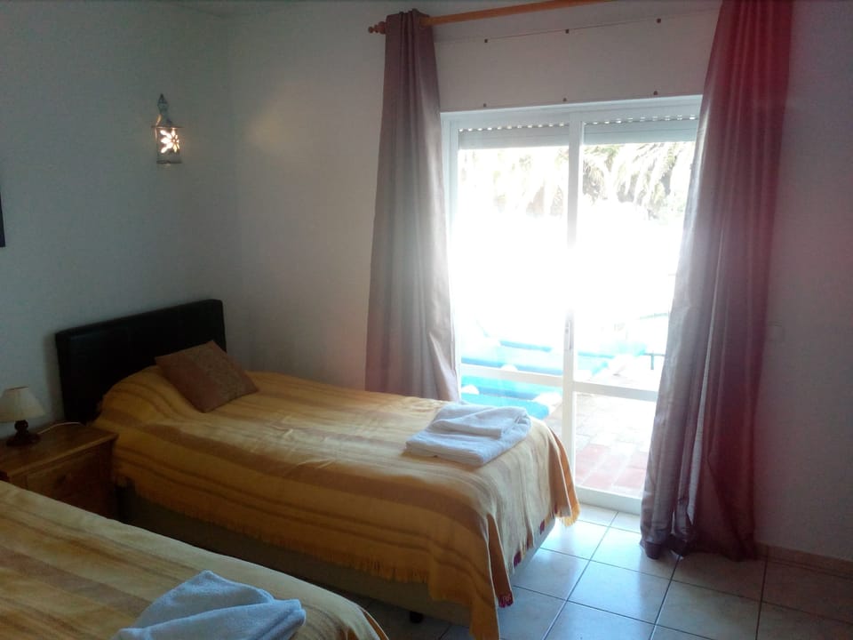 Twin Room with patio doors to pool and terrace