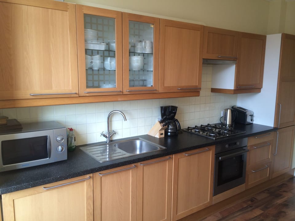 Kitchen with fridge, freezer, dishwasher, washing machine, hob, oven & microwave