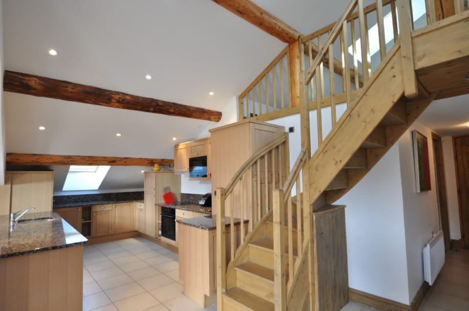 Kitchen and stairs to mezzanine