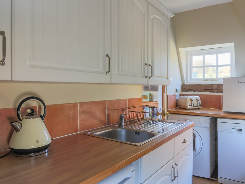 The kitchen is light and airy