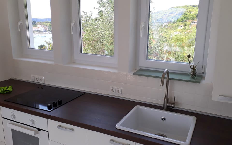 The minimalist white kitchen keeps the space uncluttered and functional