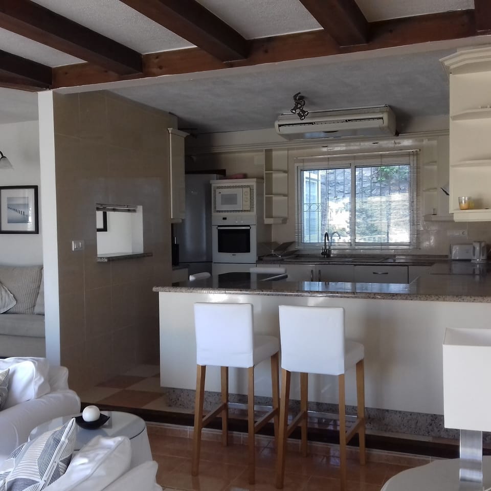 Well equipped kitchen with breakfast bar next to the sitting room.