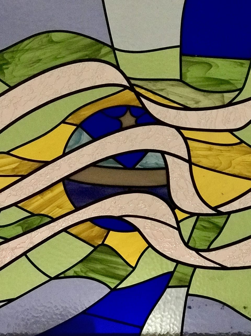 Stained glass window in vaulted living room ceiling