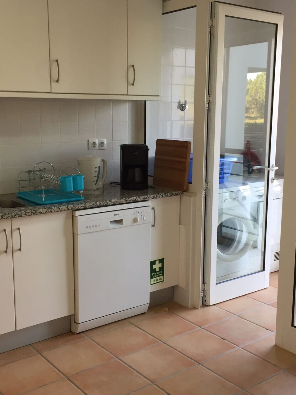 Kitchen leading to utility area