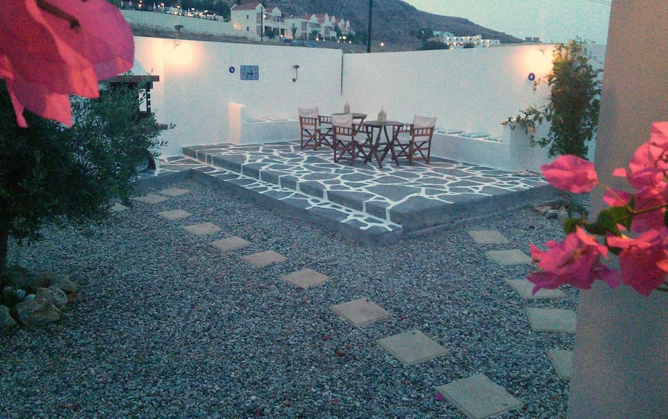 Traditional greek patio with seating and bbq
