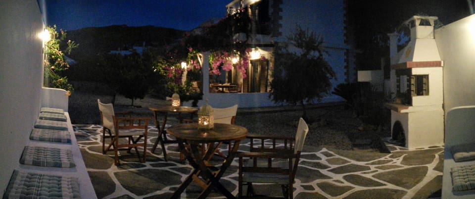 Patio and BBQ area lit up in the evening.