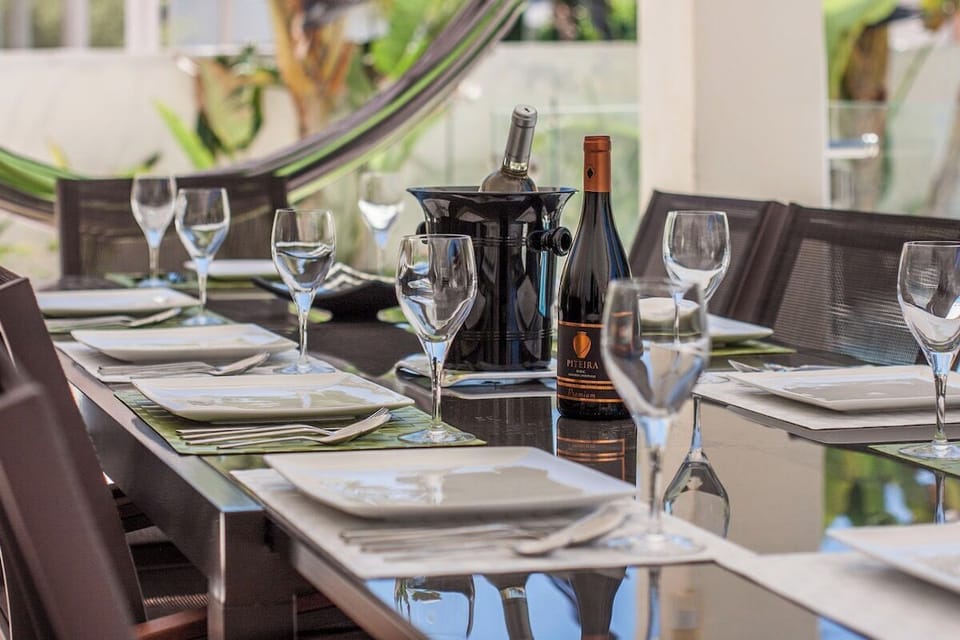 Elegant outdoor dining table with wine bottles — Villa Amendoa, luxury holiday villa in Verdizela