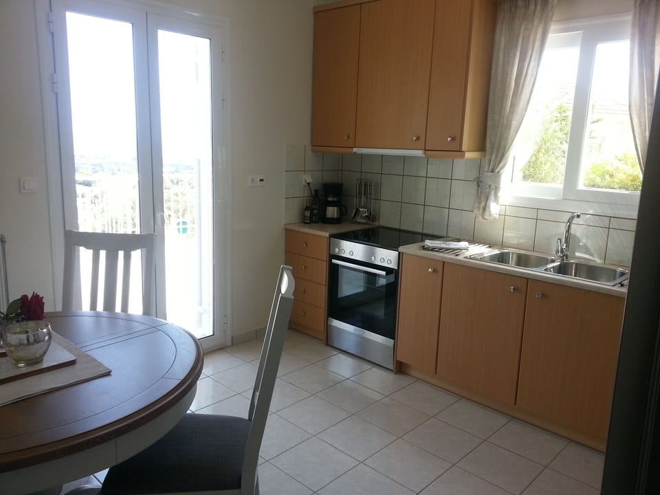 Kitchen with French doors leading to alfresco dining 