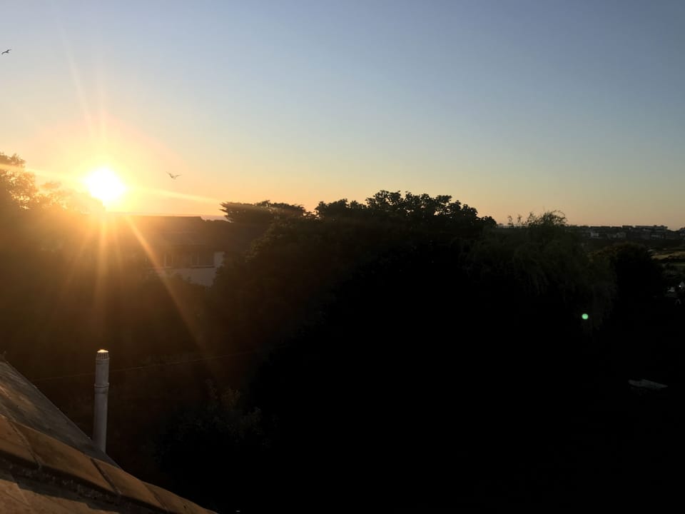 A stunning sunset over the sea as viewed from one of the four loft windows.