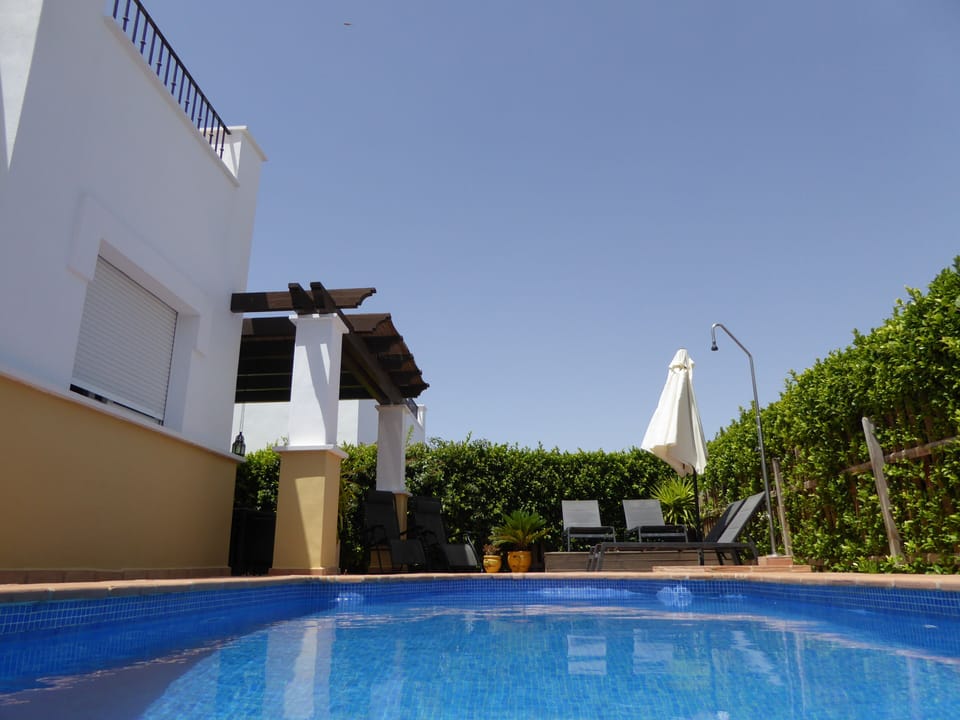 outdoor pool & sun lounger area