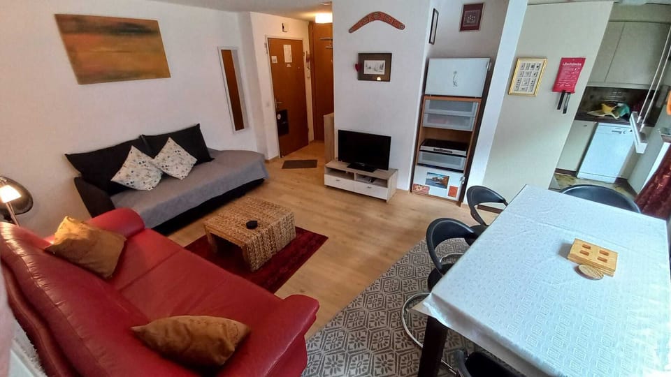 Lounge Dining with view to kitchen on right hand side showing dishwasher