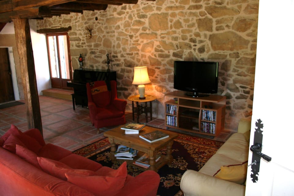 living room with piano, and satellite TV, DVD library of 'classics'