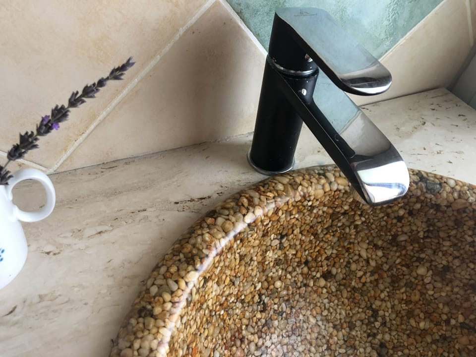 Beautiful double sinks in the main en-suite made with pebbles.
