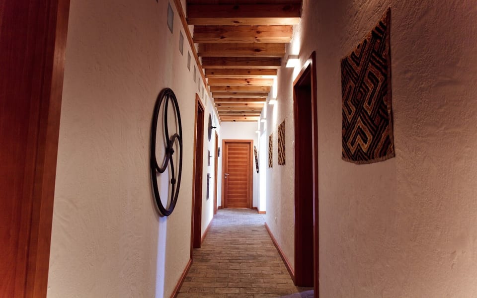 Corridor on the ground floor with doors leading to bedrooms and bathrooms