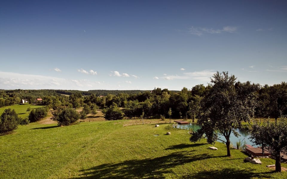 Land attached to the property with the swimming lake in the bottom right corner